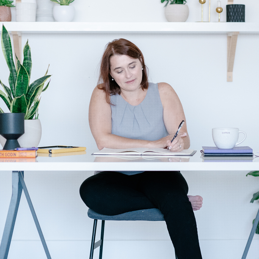 Melanie writing at a desk