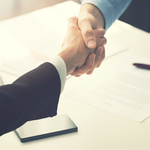 shaking hands over an office table